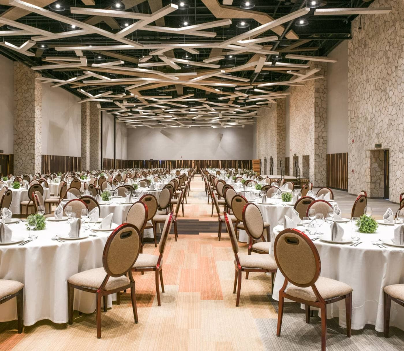 The ballroom set for a banquet with round tables
