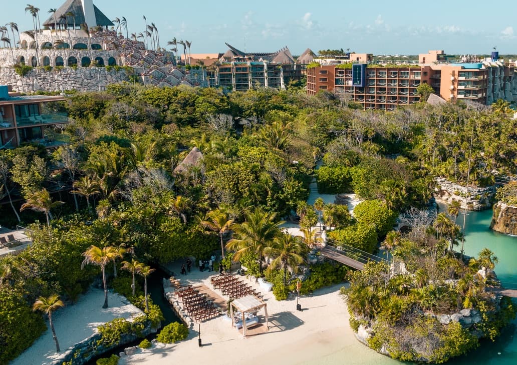 Aerial view of a wedding ceremony set up on the sand between the lagoons at Hotel Xcaret Mexico